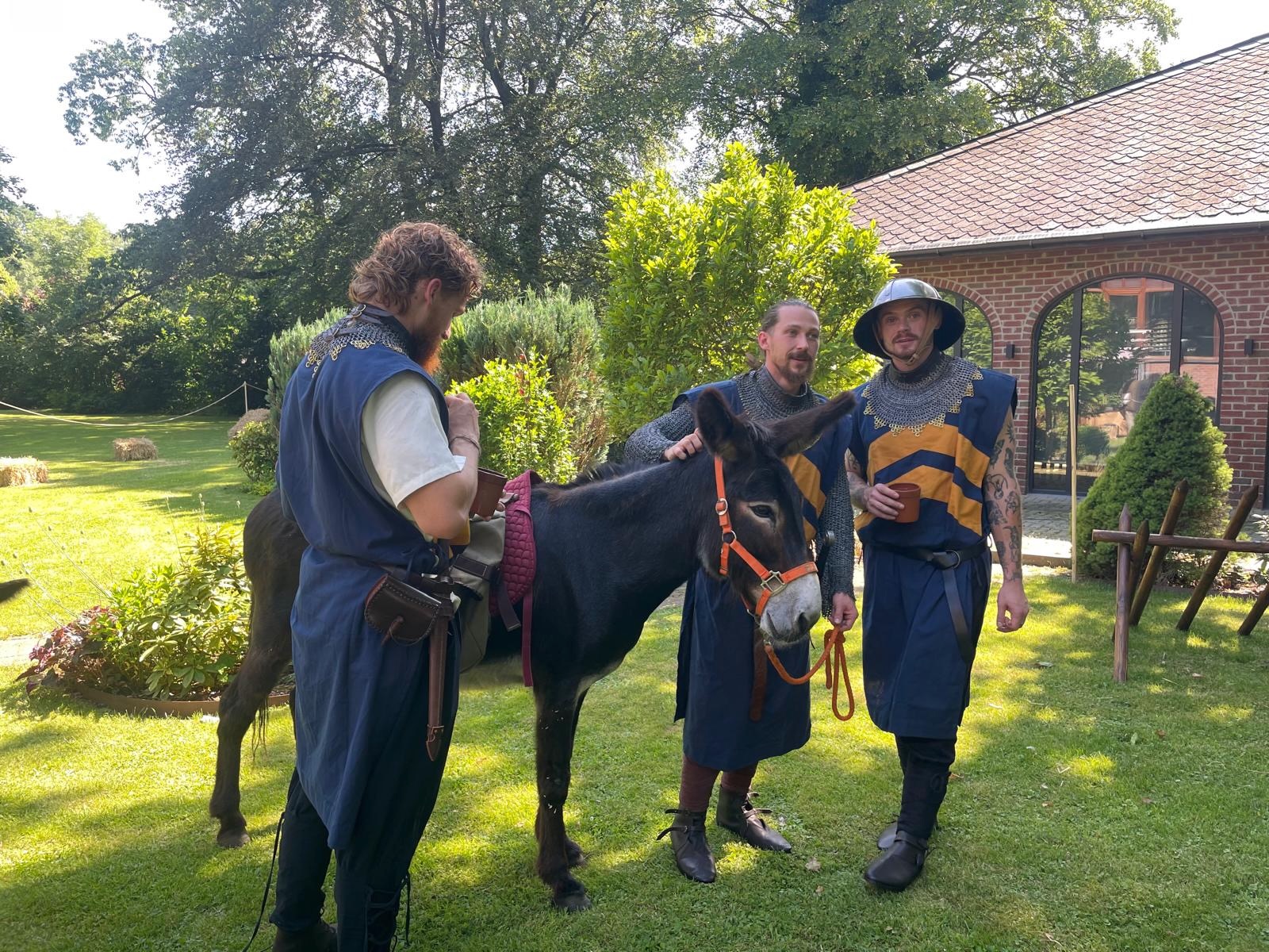 Ritter in blau-goldenen Gewändern mit einem Esel